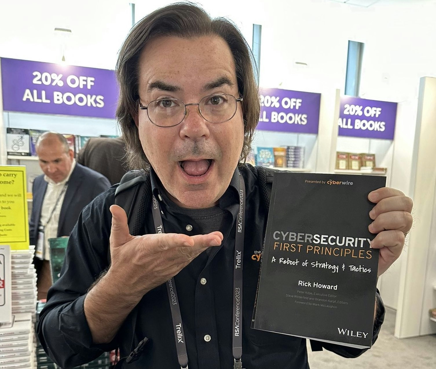 The Cybersecurity first principles book in reader's hands