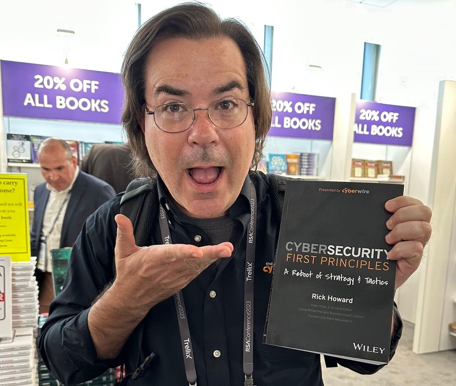 The Cybersecurity first principles book in reader's hands